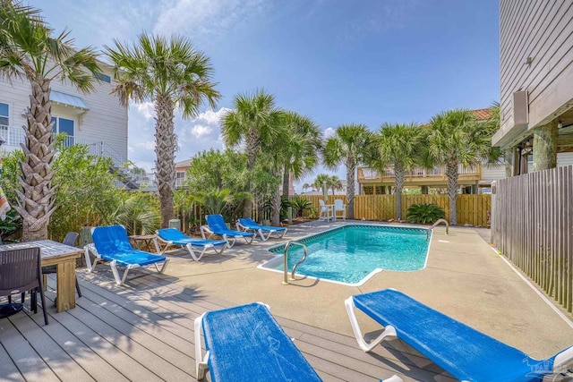 view of swimming pool with a deck