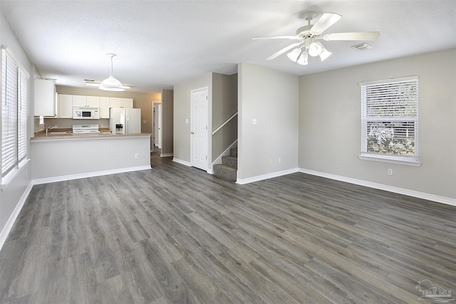 32 Enchanted Way, Santa Rosa Beach, FL 32459 - unfurnished living room with healthy amount of natural light, stairs, a sink, and baseboards
