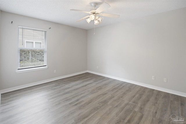 32 Enchanted Way, Santa Rosa Beach, FL 32459 - empty room featuring wood finished floors, baseboards, ceiling fan, and a textured ceiling