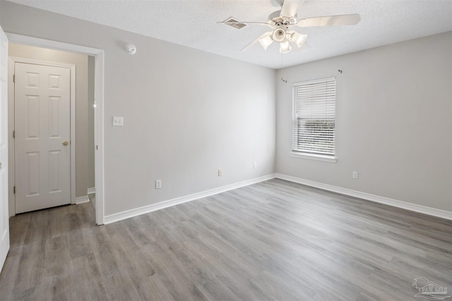 32 Enchanted Way, Santa Rosa Beach, FL 32459 - unfurnished room with ceiling fan, wood finished floors, a textured ceiling, and baseboards