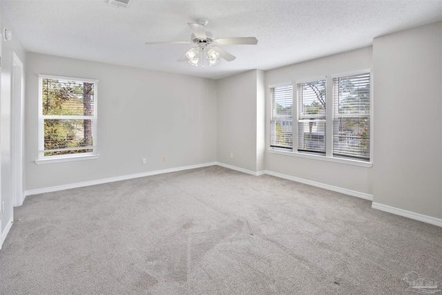 32 Enchanted Way, Santa Rosa Beach, FL 32459 - carpeted empty room with healthy amount of natural light, a ceiling fan, baseboards, and a textured ceiling