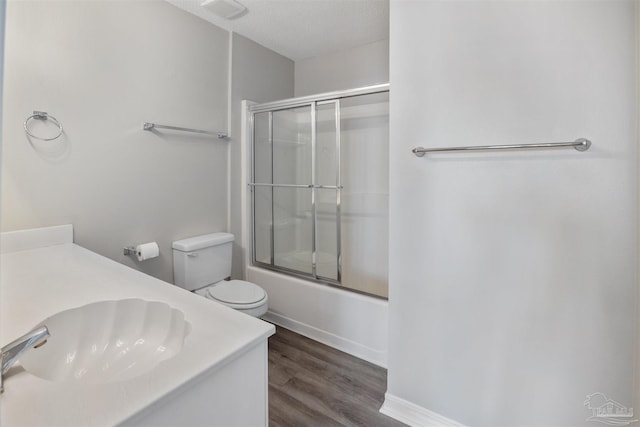 32 Enchanted Way, Santa Rosa Beach, FL 32459 - bathroom featuring wood finished floors, enclosed tub / shower combo, toilet, vanity, and baseboards