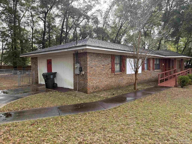 view of side of property with a lawn