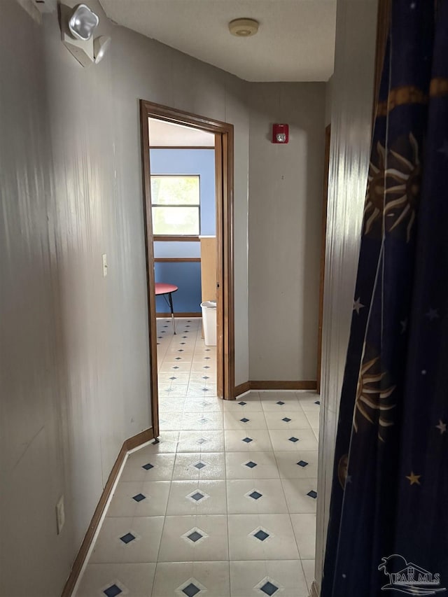 corridor with light tile patterned floors