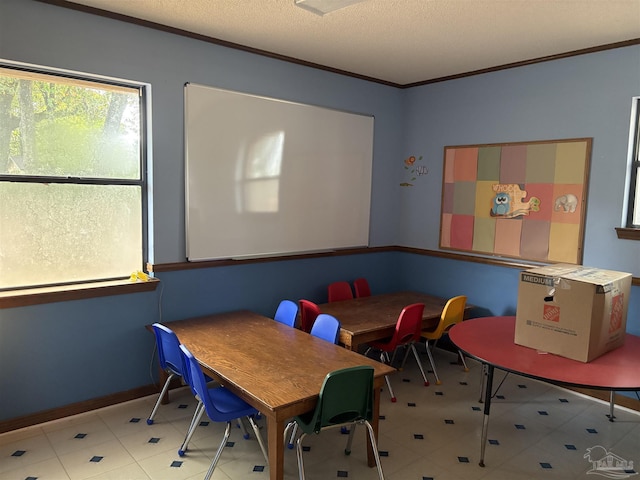 dining space featuring crown molding