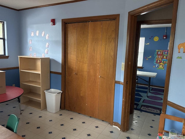 bedroom featuring crown molding and a closet