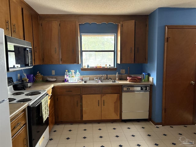 kitchen with sink, a textured ceiling, and electric range