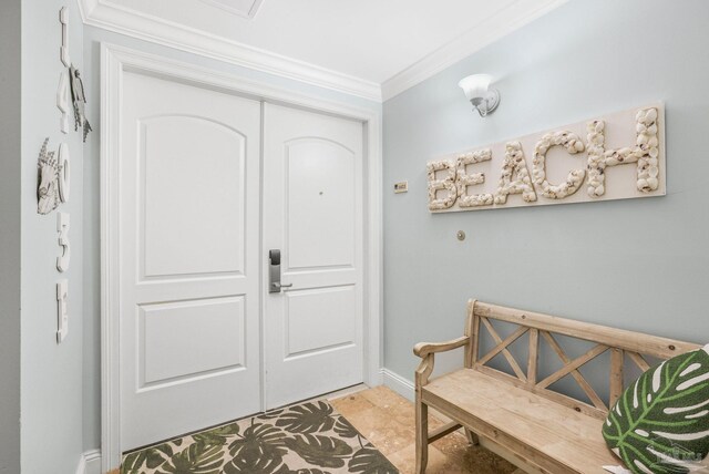 tiled foyer entrance with crown molding