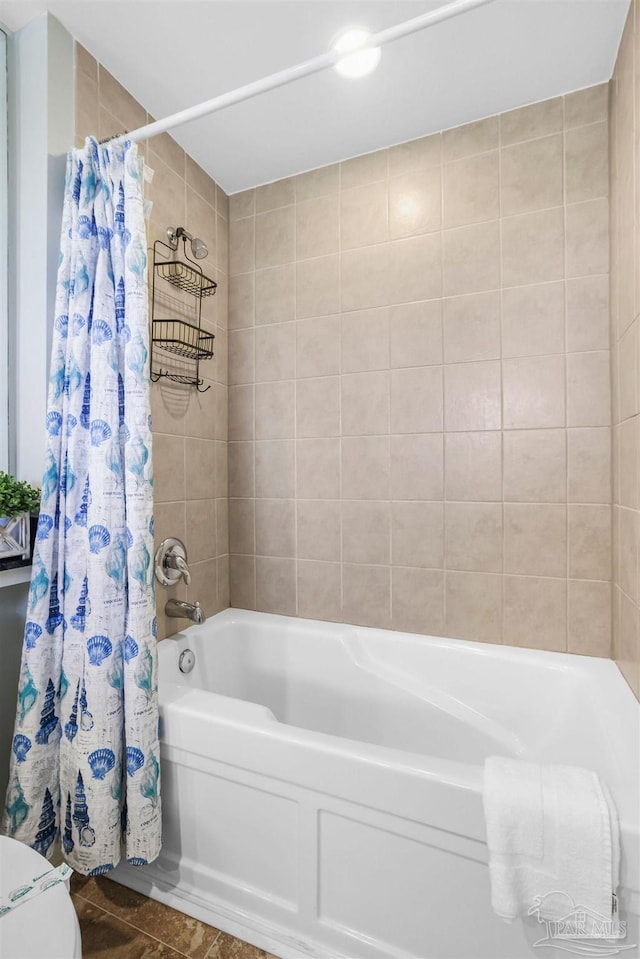 bathroom with shower / bath combo with shower curtain