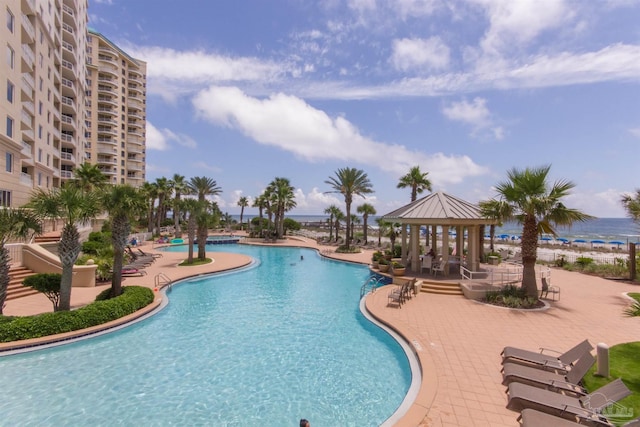 community pool featuring a gazebo and a patio area