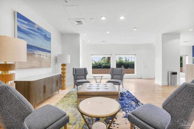 living area featuring light tile patterned floors, baseboards, visible vents, and recessed lighting