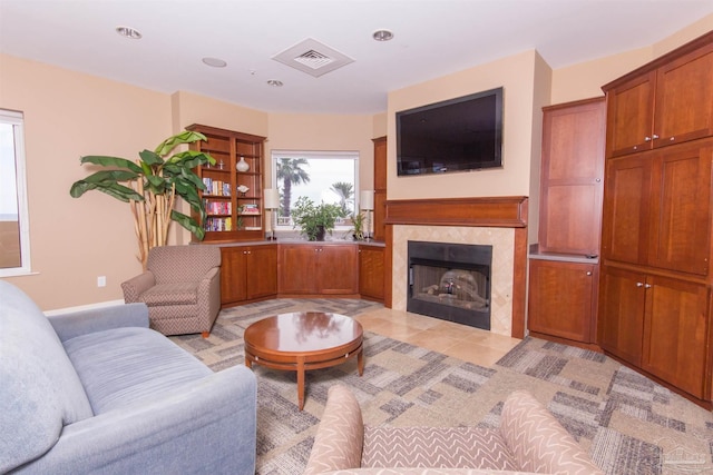 living area featuring visible vents and a tile fireplace