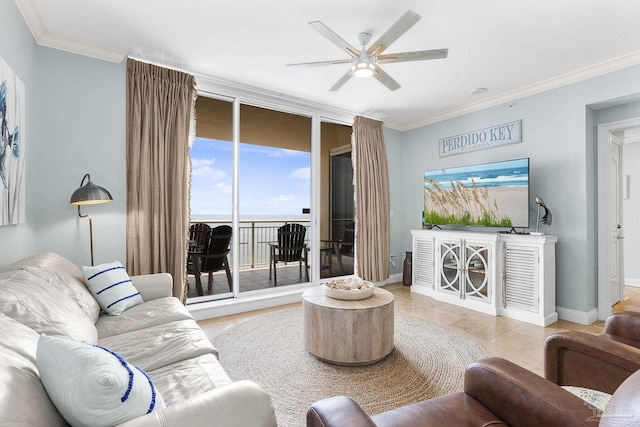 living room with ornamental molding, ceiling fan, baseboards, and light tile patterned floors