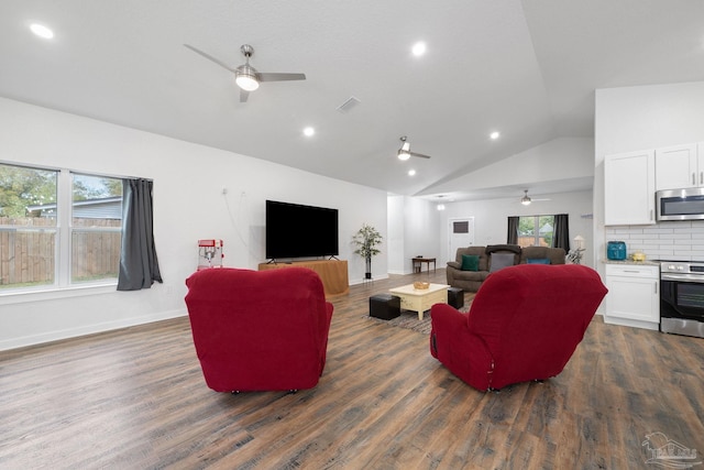 living area with dark wood finished floors, lofted ceiling, baseboards, and visible vents