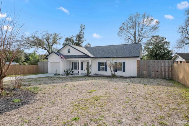 view of front facade with an attached garage and fence