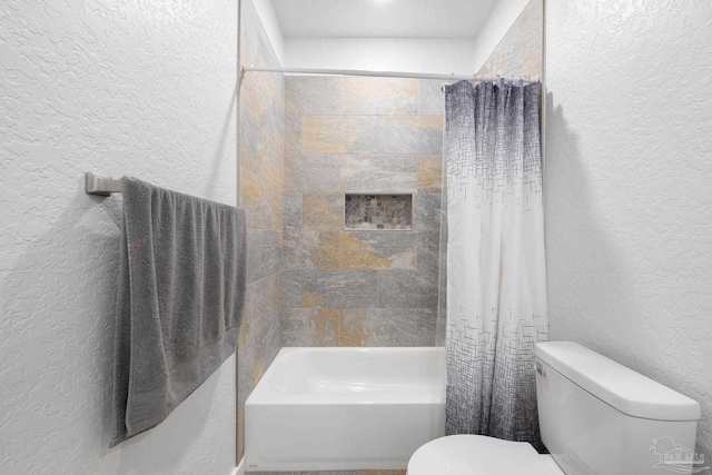 full bathroom with toilet, shower / tub combo with curtain, and a textured wall