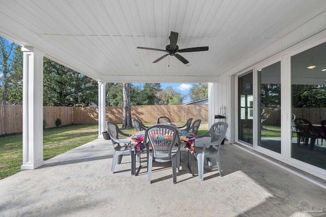 view of patio with a fenced backyard, outdoor dining area, and a ceiling fan