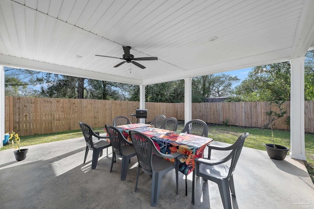 view of patio / terrace with outdoor dining area, a fenced backyard, and a ceiling fan