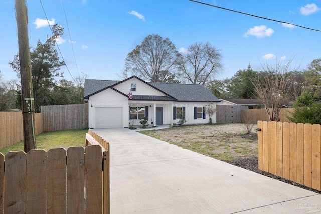 modern farmhouse style home with driveway, fence private yard, a garage, and a gate