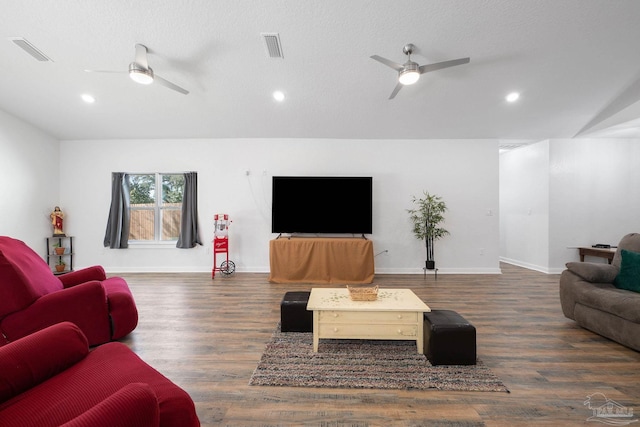 living area with visible vents, wood finished floors, and a ceiling fan