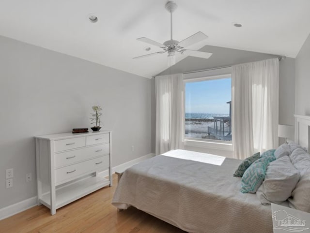 bedroom featuring lofted ceiling, light hardwood / wood-style floors, and ceiling fan