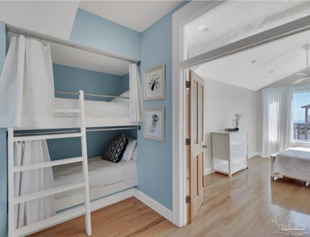 bedroom with lofted ceiling and hardwood / wood-style flooring