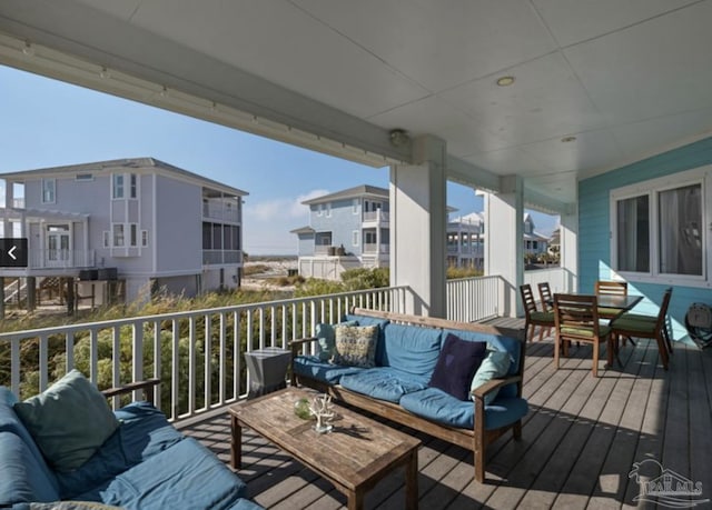 wooden terrace with an outdoor hangout area