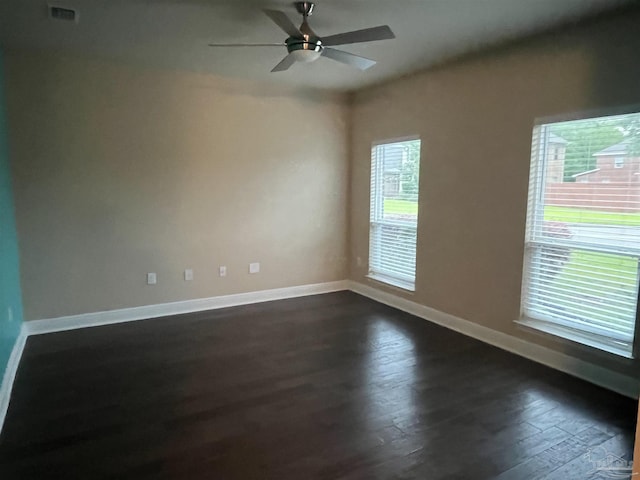 spare room with dark hardwood / wood-style floors and ceiling fan