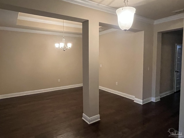 spare room with dark wood-type flooring, ornamental molding, and a raised ceiling