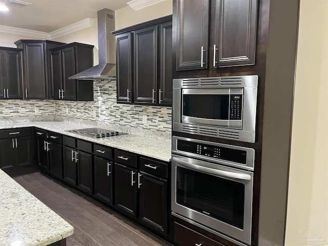 kitchen with dark hardwood / wood-style floors, tasteful backsplash, ornamental molding, stainless steel appliances, and wall chimney exhaust hood