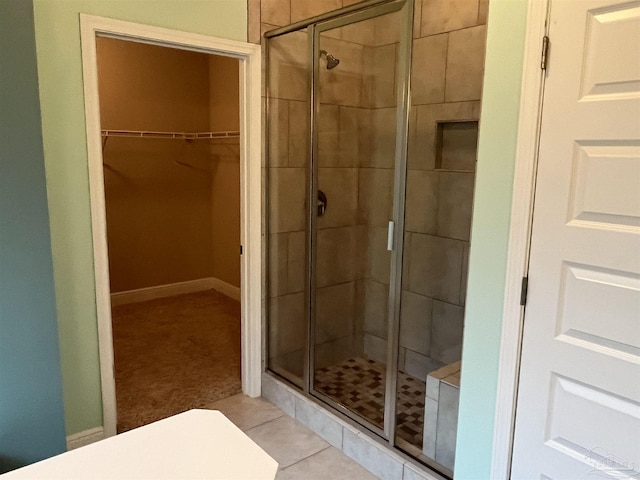 bathroom with tile patterned flooring and a shower with shower door