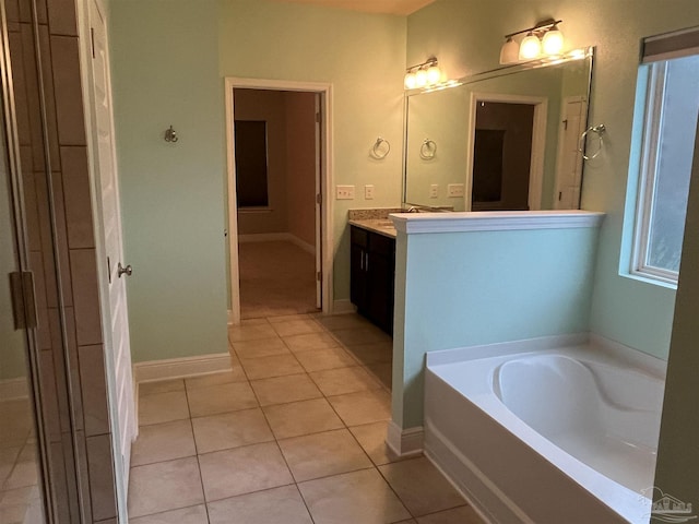 bathroom with tile patterned flooring, vanity, and a bathtub