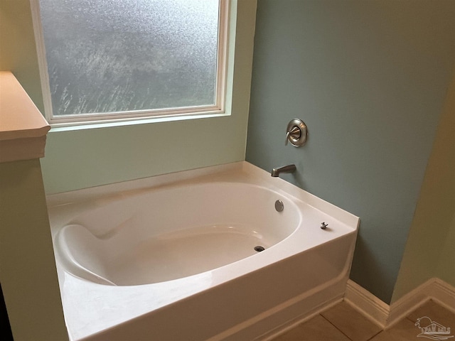 bathroom with tile patterned flooring and a tub