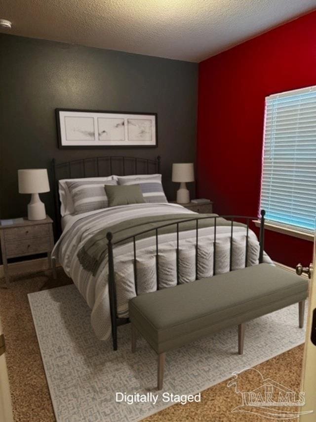 bedroom with a textured ceiling and carpet