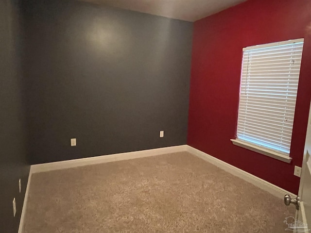 unfurnished room featuring carpet flooring