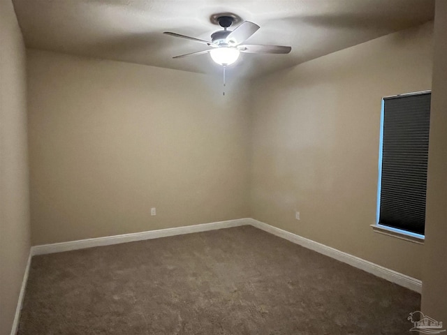 empty room featuring dark carpet and ceiling fan