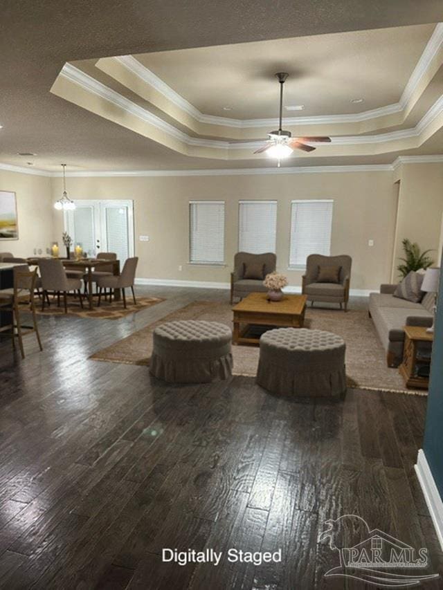 living room featuring ornamental molding and a tray ceiling