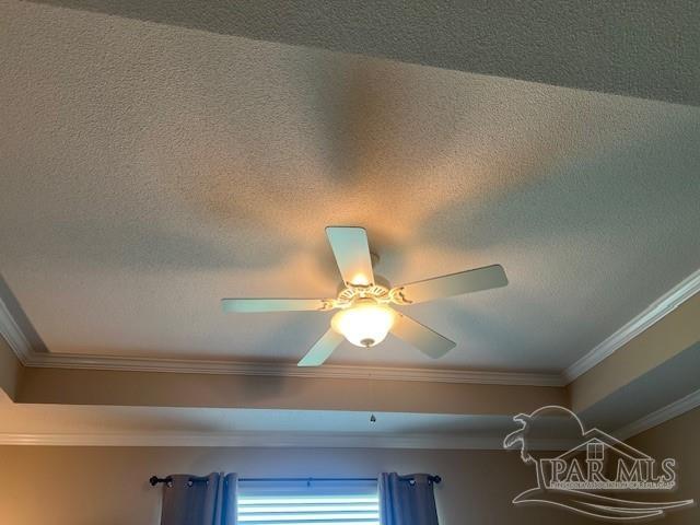 details with ceiling fan, a textured ceiling, and ornamental molding