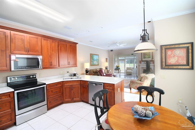 kitchen with stainless steel appliances, crown molding, decorative light fixtures, and kitchen peninsula