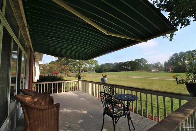 wooden deck with a lawn