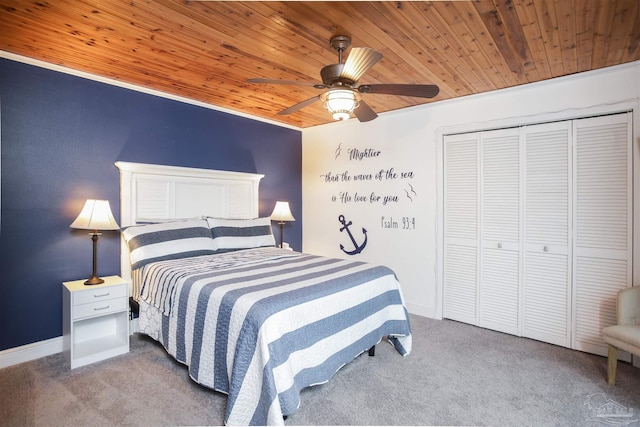 bedroom with carpet floors, crown molding, ceiling fan, wood ceiling, and a closet