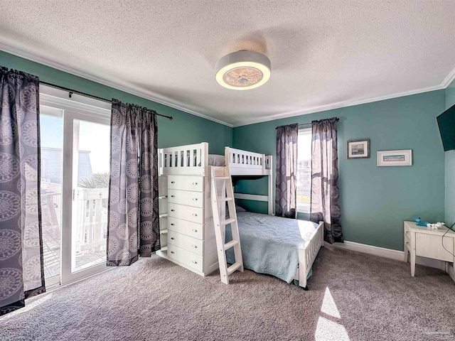 carpeted bedroom featuring multiple windows, access to exterior, a textured ceiling, and ornamental molding