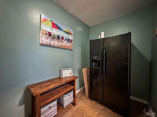 kitchen featuring black refrigerator with ice dispenser