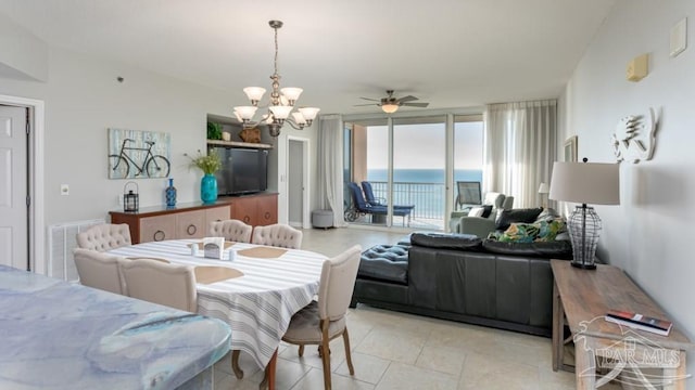 dining space featuring ceiling fan with notable chandelier and light tile patterned floors