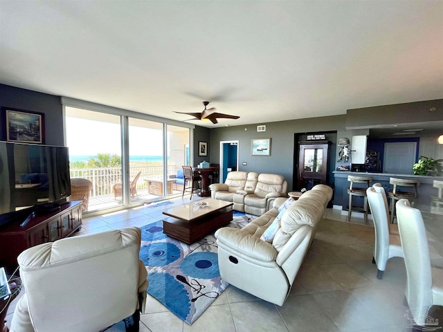 tiled living room featuring ceiling fan