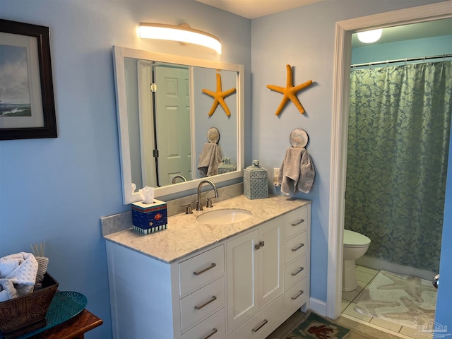 bathroom with vanity, curtained shower, toilet, and tile patterned flooring