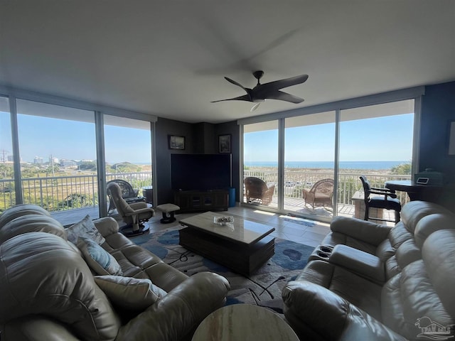 living room featuring ceiling fan, tile patterned floors, and floor to ceiling windows