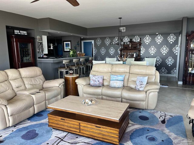 living room with light tile patterned floors and ceiling fan