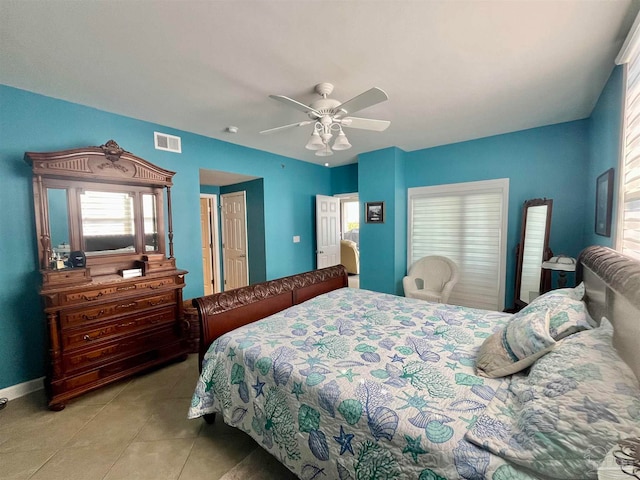 tiled bedroom featuring ceiling fan