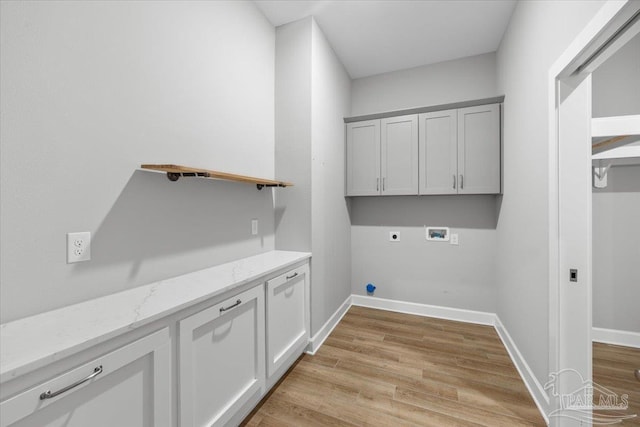 laundry room with hookup for an electric dryer, cabinets, hookup for a washing machine, and light hardwood / wood-style flooring